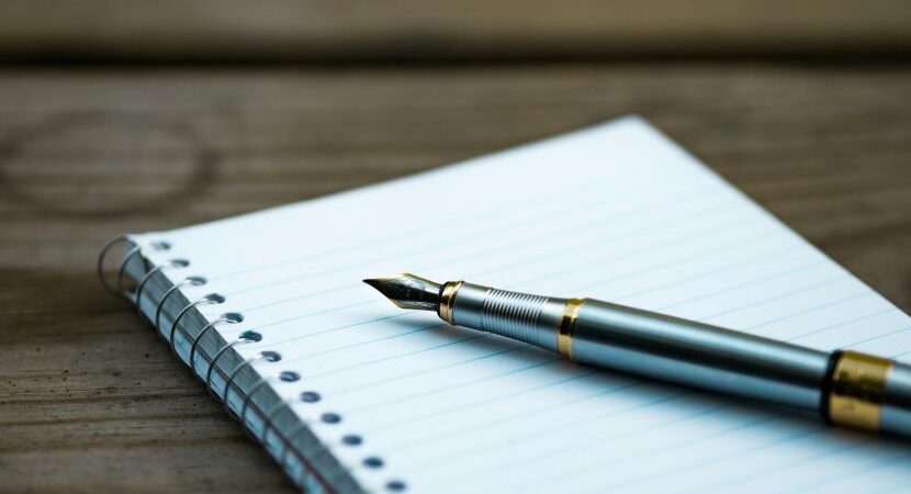 a pen on a notebook