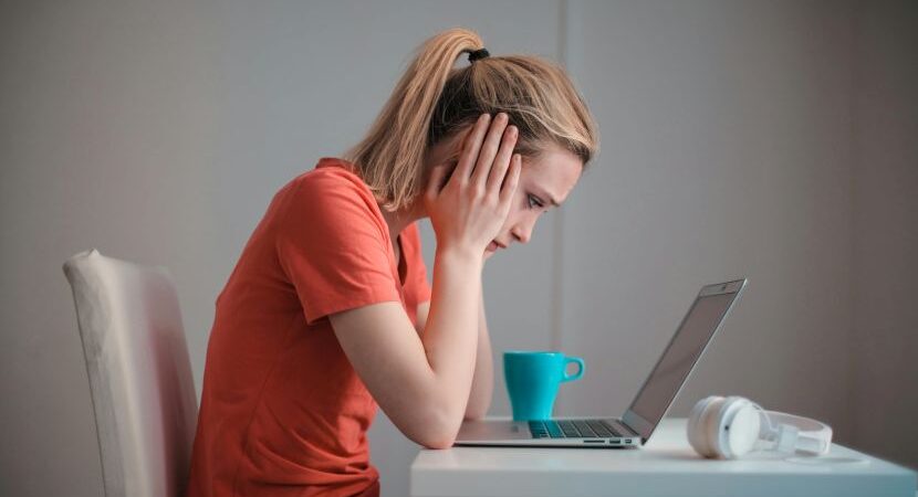 a woman sitting at a desk with a laptop